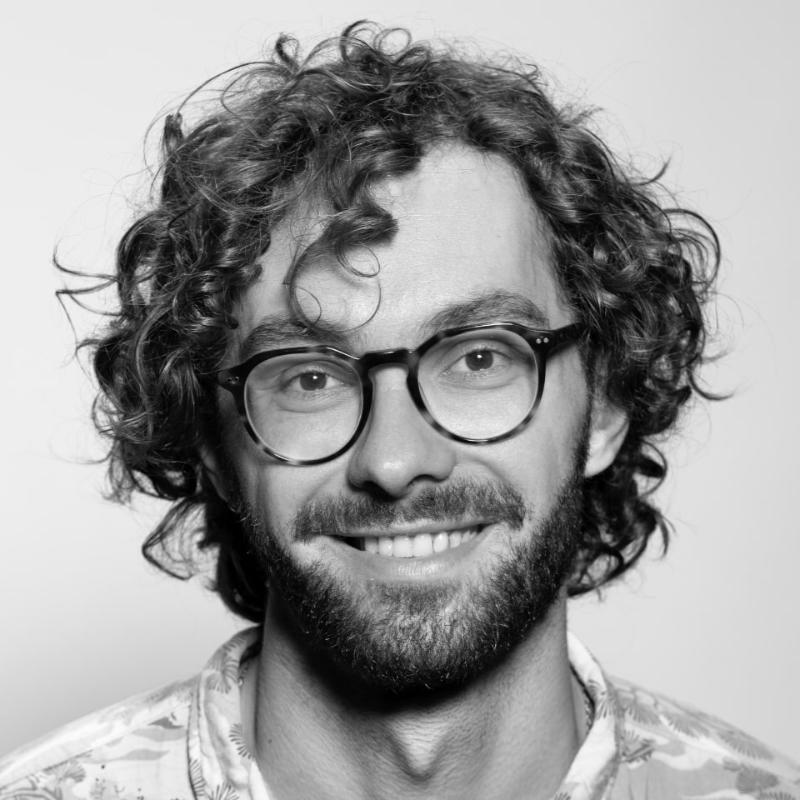 man-glasses-curly-hair-hawaiian-shirt-beard-stock-headshot